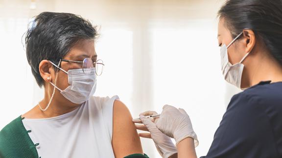 Cover image of woman getting a flu shot