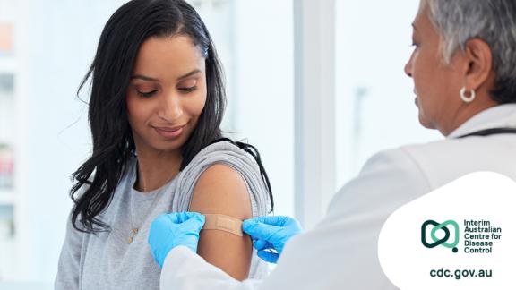 Woman getting a bandaid applied by a doctor